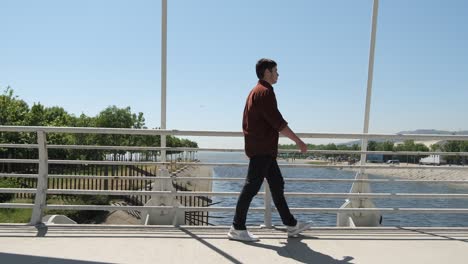 teenager passing on bridge