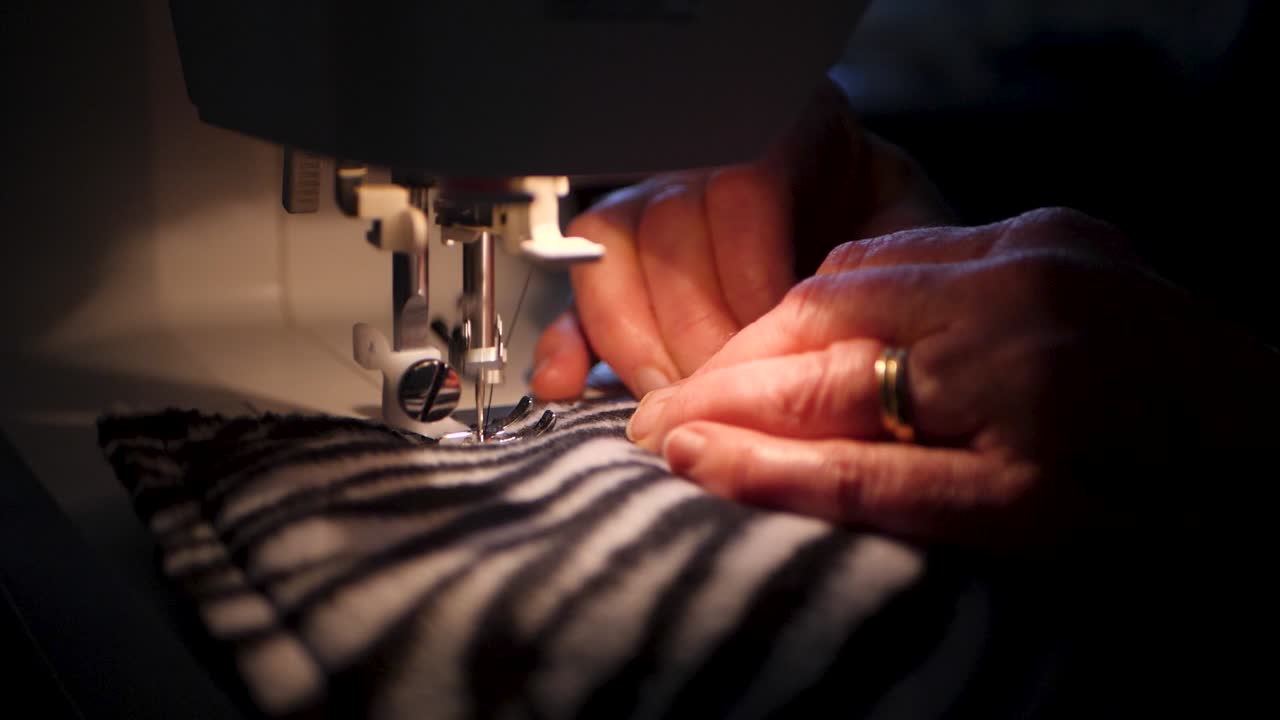 A slow-motion clip of a sewing machine working on zebra printed fabric