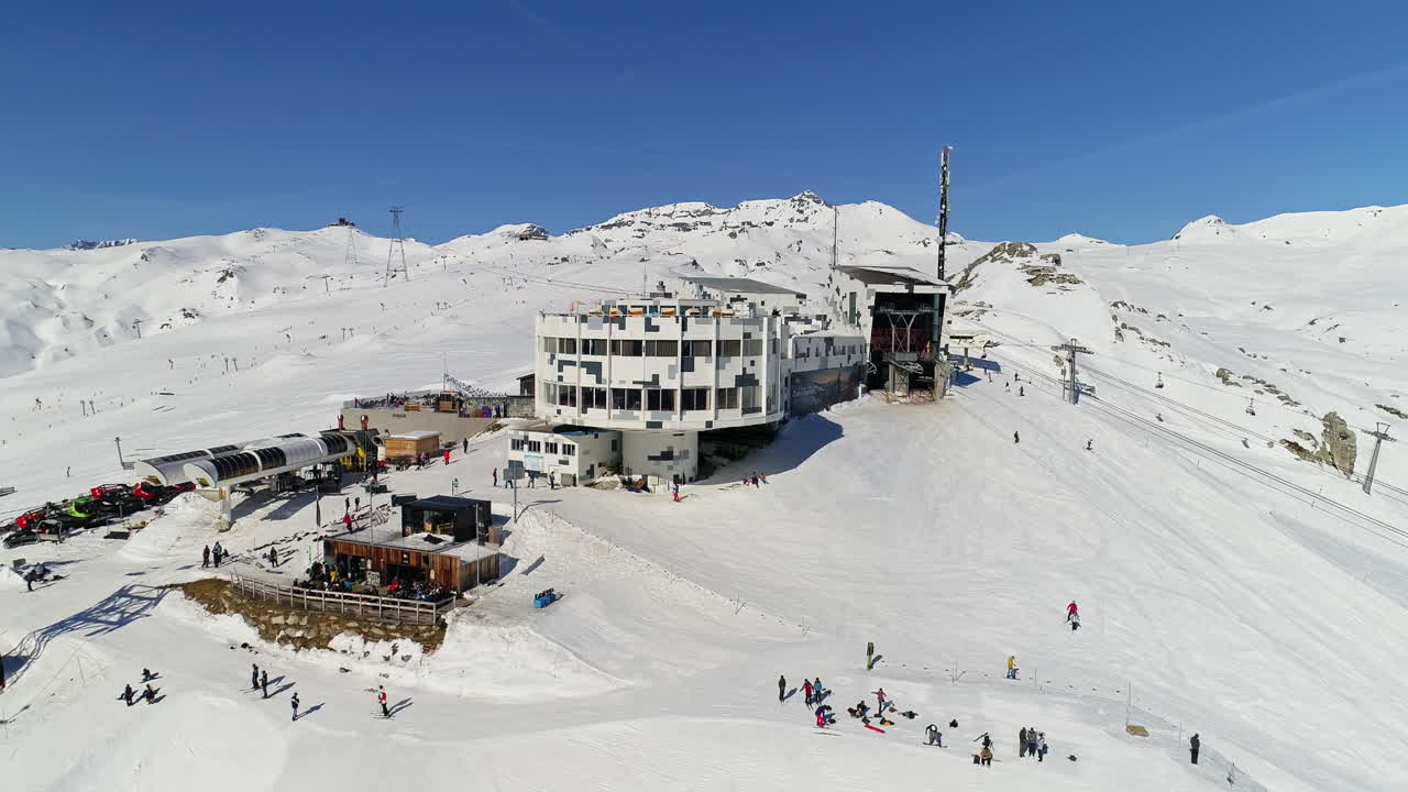 Dynamic freestyle skier throwing big airs and stylish tricks on rails at Laax Snowpark, Switzerland—capturing high-level performance, style, and action in a world-class winter setting.