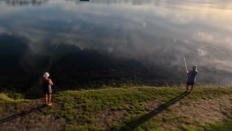 person fishing alone by a calm lake