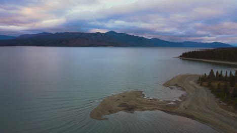 kluane lake at dramatic winter sunset on calm evening, aerial drone