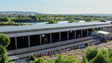 abandoned railway freight station depot with graffiti, spanish countryside