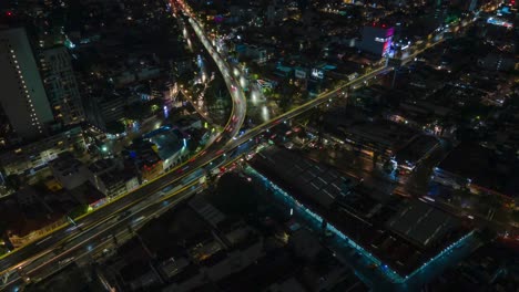 Aerial-nighttime-hyperlapse-of-a-busy-intersection-in-Mexico-City,-circle-pan