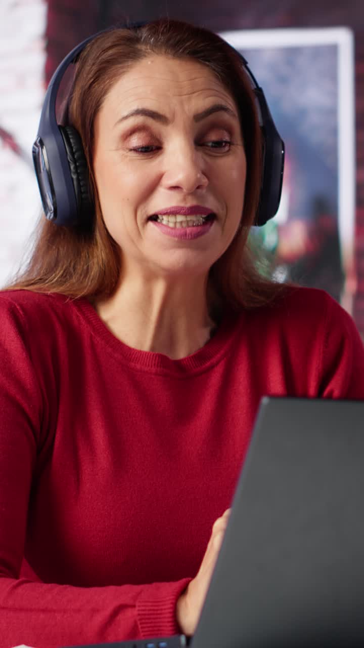 Vertical Video Joyful woman hosting a virtual family meeting online via video conference