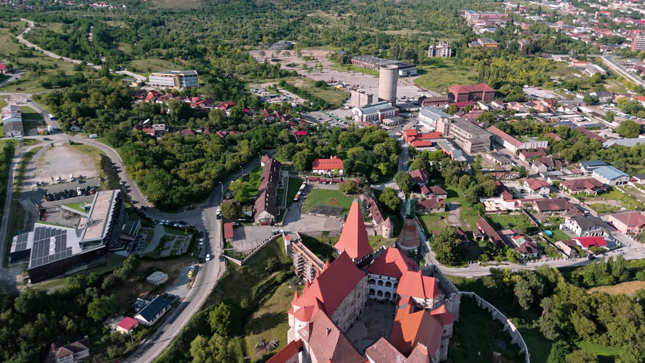 Aerial view of Corvin Castle in Hunedoara surrounded by greenery