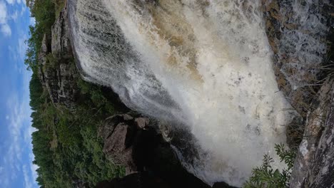 Slow-motion-video-of-a-waterfall-with-a-huge-volume-of-water,-vertical-format