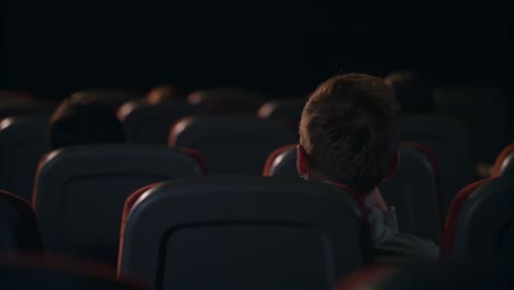 people sitting in cinema. back view. napes of spectators sitting in theatre