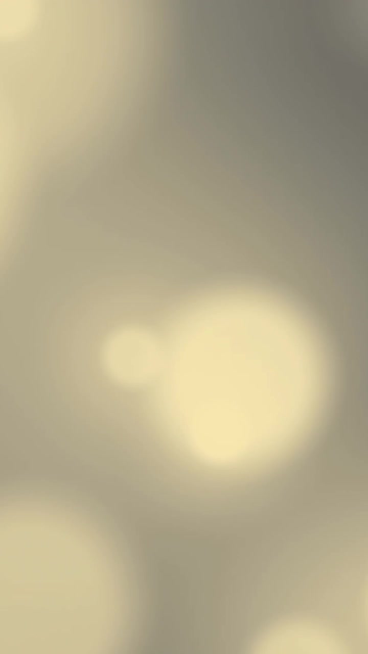 Animazione di punti luce gialli luminosi tremolanti su sfondo grigio