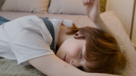 Girl-Lying-On-The-Bed-In-Bedroom-Smiling-And-Looking-At-Camera-1