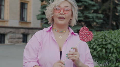 woman enjoying a lollipop outdoors