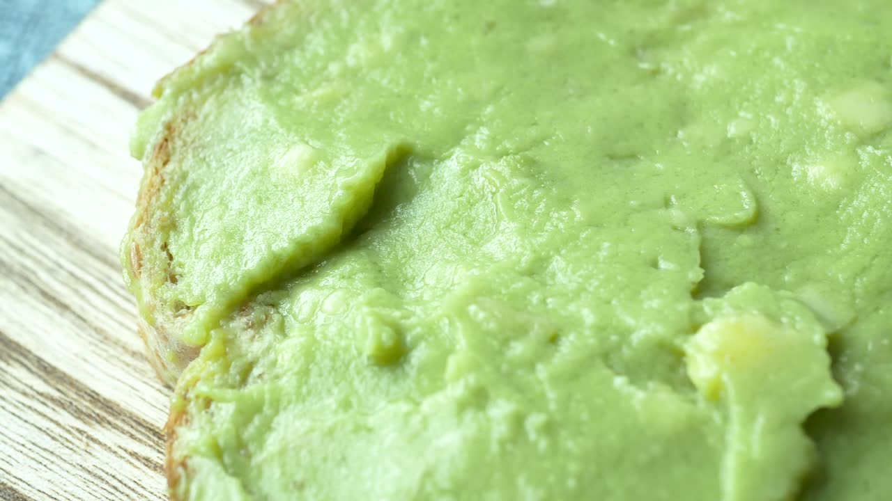 Avocado spread on a chopping board ,