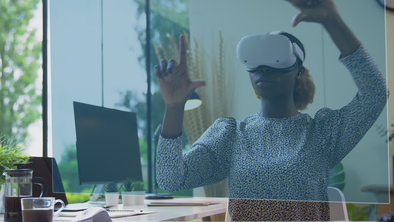 Woman Looking At Projected Screen Sitting At Desk Wearing VR Headset Interacting With AR Technology