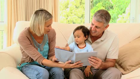 parents with their baby looking at an album