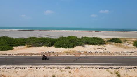 panoramic aerial drone shot of dhanushkodi, highlighting the untouched beaches and shimmering ocean waters.
