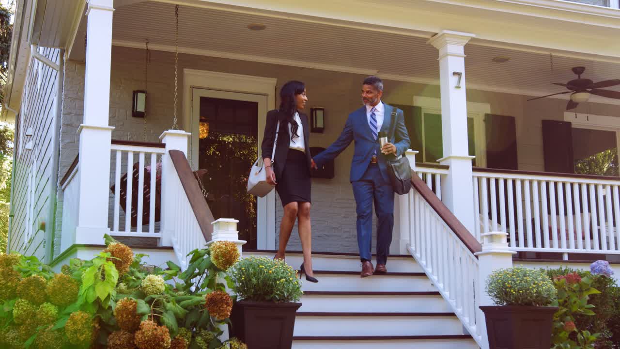 Businessman With Cup Of Coffee Walks Along Suburban Street