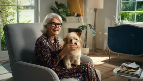 woman sitting in a chair petting her dog