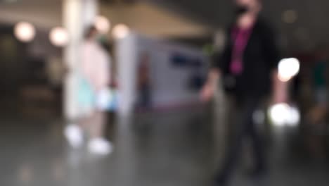 blurred indoor shot of people walking