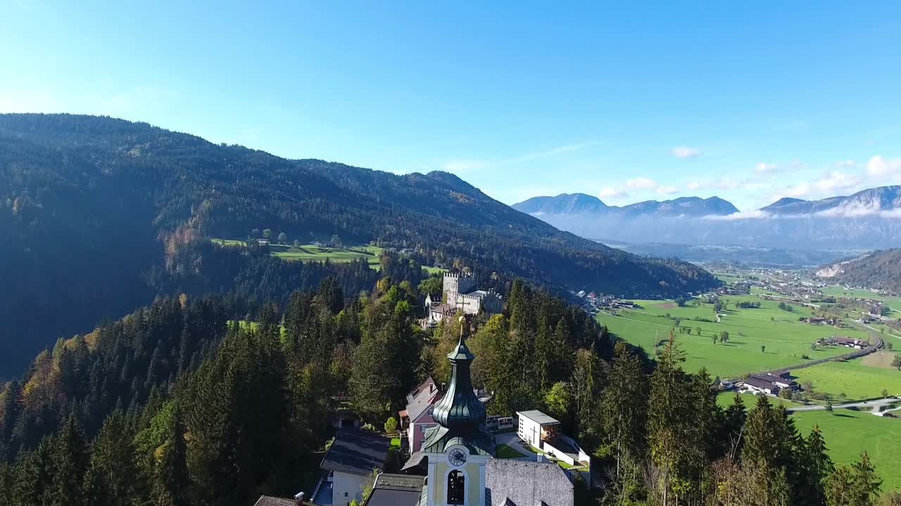 AERIAL, SLOMO, Flight with the DJI Phantom 4 in tyrol in front of a church and then a nice view over the castle Itter to the Inntal.