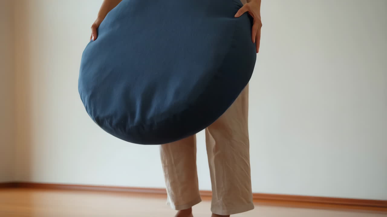 Person Setting Up a Meditation Floor Cushion