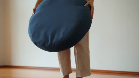 Person Setting Up a Meditation Floor Cushion
