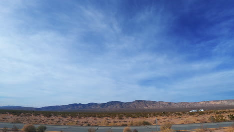 looking out the side window as the vehicle travels through the mojave desert landscape - passenger point of view hyperlapse