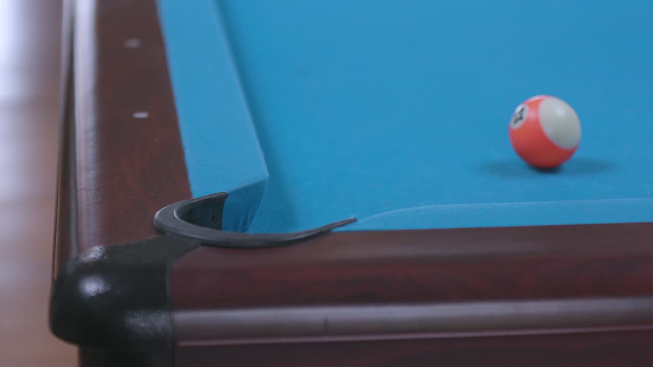 Man Missing Pool Ball Shot in Corner Pocket on Blue Billiards Table