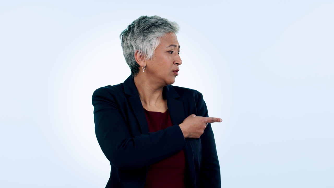 Pointing, serious and a mature business woman