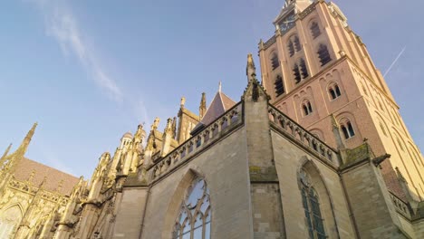 saint john's cathedral in 's- hertogenbosch den bosch in netherlands, low angle view of the building chapel, blue sky and spires, authentic traditional dutch european architecture style design