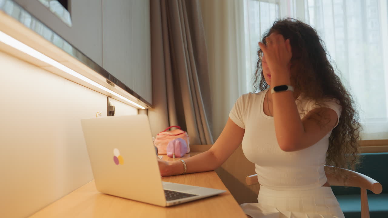 Woman unwinds inside. Calm lady savors tranquil pause. Relaxed woman reflects peacefully as she sips coffee by window. Composed woman finds serenity in quiet hotel room as she enjoys her coffee