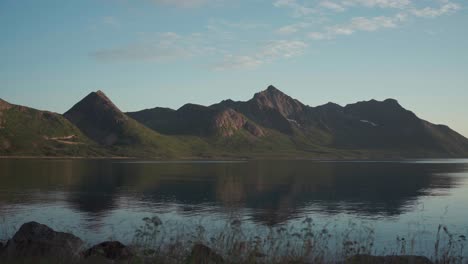 panorama of mountain range with reflection on calm lake