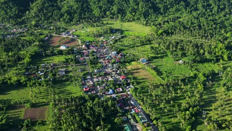 picturesque aerial pullback of provincial barangay town surrounded by lush tropical scenery at san andres, catanduanes, philippines