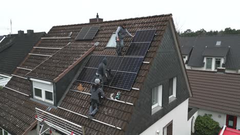 workers installing solar panels on a residential rooftop