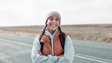 smiling woman with arms crossed on a road