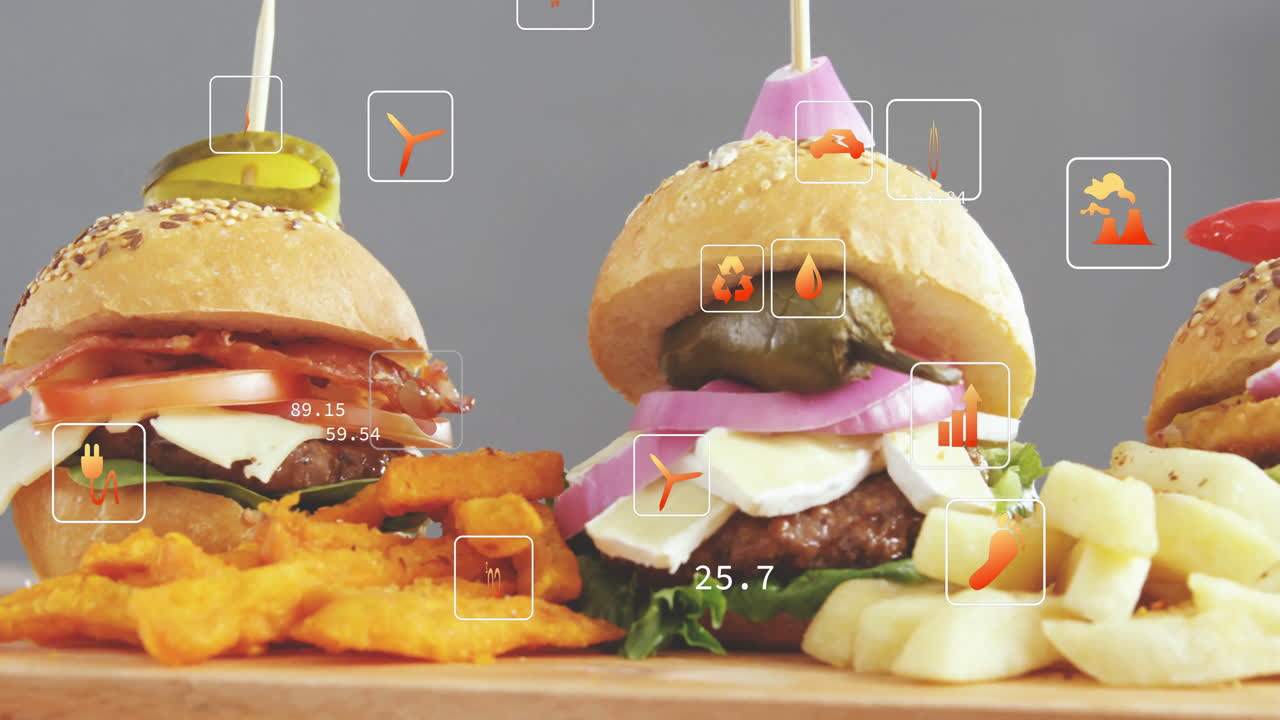 Burgers and fries with nutritional data overlay animation on wooden board