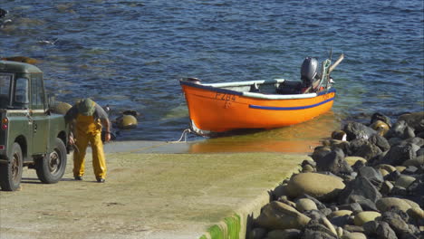 fisherman hauls his boat up ramp from cape cornwall water