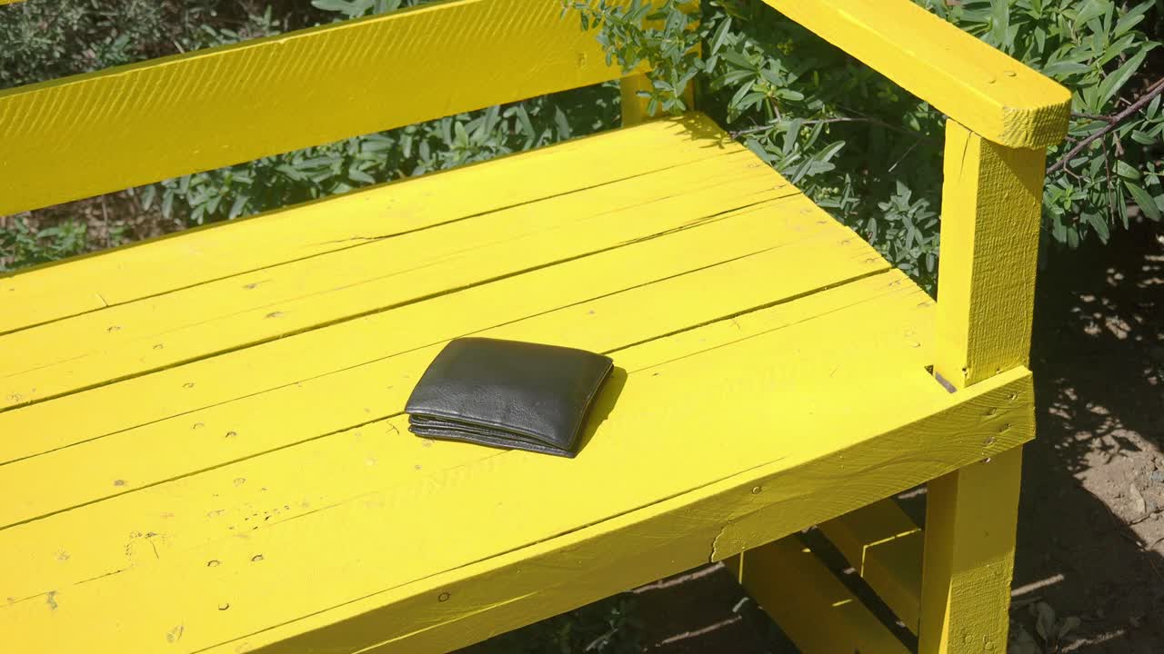 Lost wallet on a yellow bench