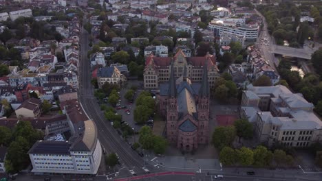 aerial view of catholic church johanneskirche of gothic old town of freiburg im breisgau during sunset, germany