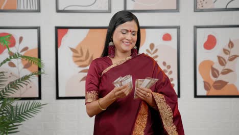 Happy-Indian-woman-counting-money