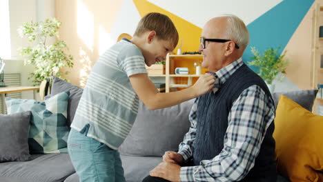 grandson helping grandpa dress