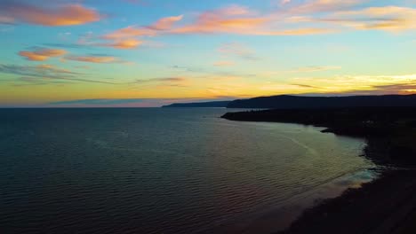 a high drone shot over the bay of fundy coastline near waterside beach, new brunswick at dusk