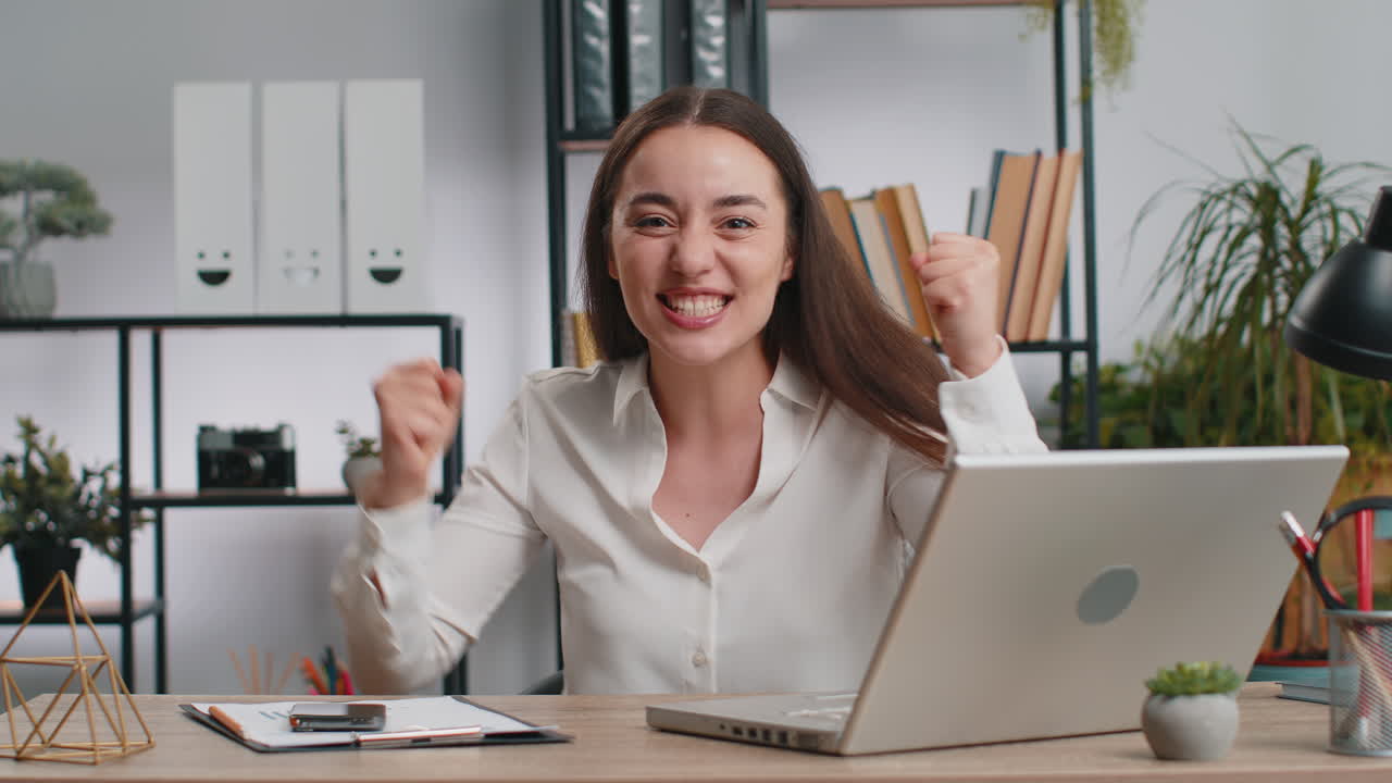 Happy amazed businesswoman shocked by sudden victory game winning lottery goal achievemen good news