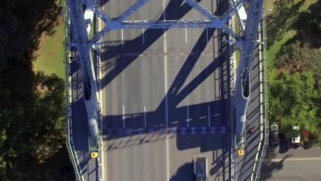 Downward-angle-on-Story-Bridge---aerial-shot-moving-across-the-bridge-revealing-the-traffic,-with-the-park-beneath-the-bridge