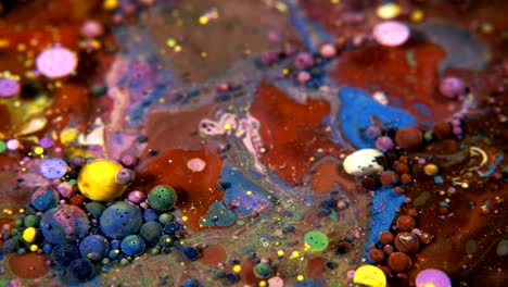 abstract colorful acrylic and food paint bubbles on water