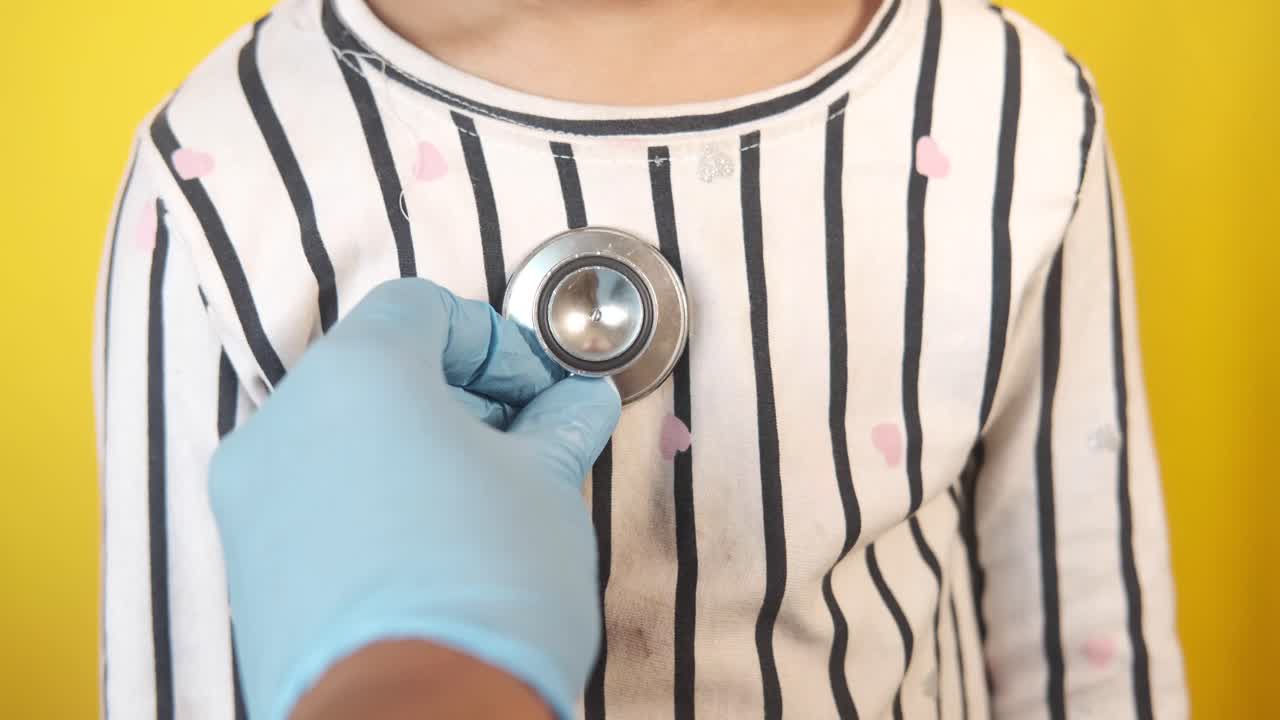 Doctor examining a child's heart with a stethoscope