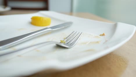 Empty-plate-after-eating-on-table-,