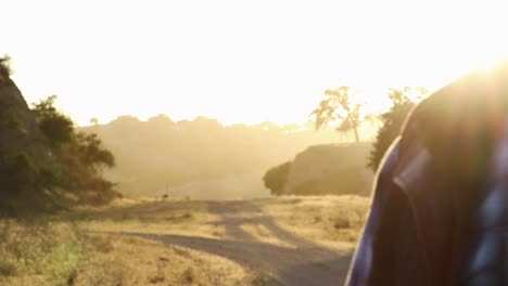 Cinematic-shot-of-cowboy-standing-strong-with-beautiful-lighting-behind-him