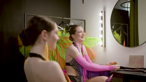 three showgirls laughing in the backstage