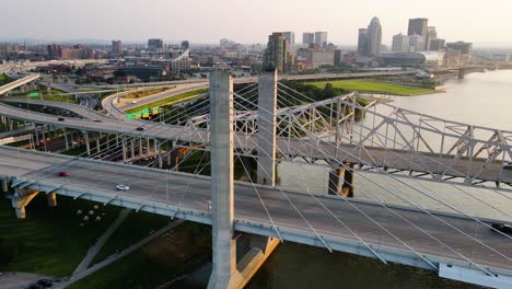 aerial view of the louisville cityscape and bridge, sunny evening in usa - pan, drone shot