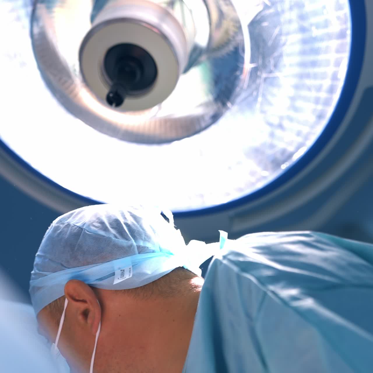 Surgeon specialist focused on his work at operating room. Portrait of a confident professional during surgical operation. Close up. Low angle view