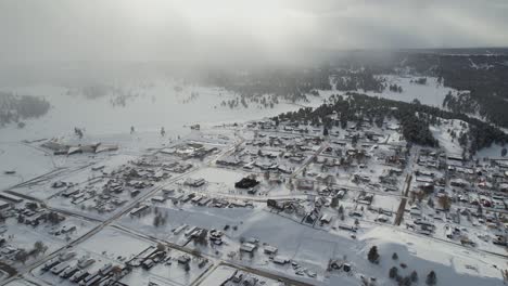 Drone-Shot-of-Pagosa-Springs-Colorado-USA-in-Winter-Season,-Snow-Capped-Buildings,-Streets-and-Landscape